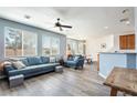Bright, open living room with modern ceiling fan and hardwood floors, lots of light from the windows at 6121 Mission Gorge Ct, Las Vegas, NV 89130