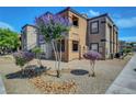 Two-story apartment building featuring desert landscaping and exterior lighting at 6650 W Warm Springs Rd # 1083, Las Vegas, NV 89118