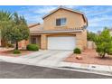 Charming two-story home featuring a tile roof, a spacious two-car garage, and mature landscaping at 682 E Sole Addiction Ave, Las Vegas, NV 89183