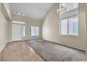 Spacious living room with high ceilings, new carpet, and large windows offering plenty of light at 682 E Sole Addiction Ave, Las Vegas, NV 89183