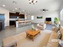 Bright, open living room with modern furnishings, seamlessly connected to the kitchen and dining area at 6918 Dandelion Park Ave, Las Vegas, NV 89113