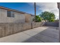 Spacious backyard featuring a concrete patio and block wall at 7240 Wandering Star Ct, Las Vegas, NV 89131