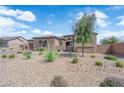 Charming single-story home featuring desert landscaping, stone accents, and a neutral color palette, captured on a sunny day at 7258 W Le Baron Ave, Las Vegas, NV 89178