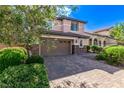 Charming two-story home with a brick driveway and lush landscaping, plus a two car garage at 7325 Perkins Hill St, Las Vegas, NV 89166