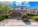 Charming two-story home with a brick driveway and lush landscaping at 7325 Perkins Hill St, Las Vegas, NV 89166