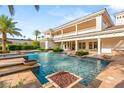 Resort-style pool and spa with lush landscaping and a spacious patio, perfect for relaxation and outdoor entertaining at 8895 S Tenaya Way, Las Vegas, NV 89113