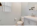 Well-lit powder room featuring a modern vanity and a round mirror at 928 Shades End Ave, North Las Vegas, NV 89081