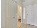Bright entryway featuring a front door with sidelight and a view of the powder room at 928 Shades End Ave, North Las Vegas, NV 89081