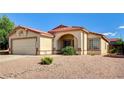 Well-maintained single-story home featuring a tiled roof and a desert-landscaped front yard at 931 Highland Trails Ave, Henderson, NV 89015