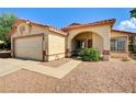 Inviting single-story home with a two-car garage and desert-style front yard at 931 Highland Trails Ave, Henderson, NV 89015