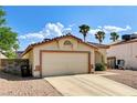 Charming single-story home with a two-car garage and low-maintenance desert landscaping at 931 Highland Trails Ave, Henderson, NV 89015