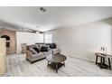 Bright living room featuring modern flooring, neutral paint, and comfortable seating area at 931 Highland Trails Ave, Henderson, NV 89015