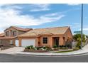 Inviting single-story home with a tile roof, complemented by a well-kept front garden at 9329 Mountain Cliffs Ave, Las Vegas, NV 89129