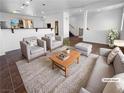Bright, staged living room with modern furniture, neutral tones, and a cozy rug at 9384 Hosner St, Las Vegas, NV 89178