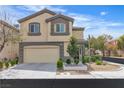 Two-story home featuring a two-car garage, manicured landscaping, and neutral color palette at 9713 Kampsville Ave, Las Vegas, NV 89148