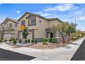 Two-story home with a two-car garage, landscaped front yard, and charming curb appeal at 9713 Kampsville Ave, Las Vegas, NV 89148