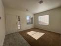 Inviting carpeted living room with two windows and a view of the front entrance at 1030 Country Skies Ave, Las Vegas, NV 89123