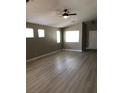 Bright living room boasts wood-look floors, neutral walls, and multiple windows for natural light at 10342 Spider Rock Ave, Las Vegas, NV 89135