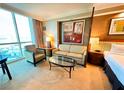 Relaxing living room area with large windows, comfortable seating, and a modern aesthetic at 125 E Harmon Ave # 2718, Las Vegas, NV 89109