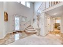 Bright foyer featuring a grand staircase, marble floors, and a decorative front door at 1367 Minuet St, Henderson, NV 89052