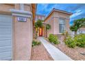 Inviting home with a decorative front door, manicured landscaping, and a charming walkway at 1367 Minuet St, Henderson, NV 89052