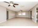 Spacious living room featuring neutral paint, tile floors, and ceiling fans at 1509 Lucilee St, Las Vegas, NV 89101
