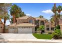 Charming two-story home boasts a three-car garage, desert landscaping, and a welcoming curb appeal at 1990 Freeman Ct, Henderson, NV 89014