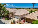 Charming single-story home featuring lush landscaping and a beautiful tile roof at 2149 Eaglepath Cir, Henderson, NV 89074