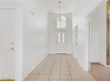 Inviting foyer with tiled floors and a view of the front door and living spaces at 2149 Eaglepath Cir, Henderson, NV 89074