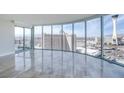 Bright, open living room boasts floor-to-ceiling windows showcasing a panoramic city view and marble floors at 222 Karen Ave # 2308, Las Vegas, NV 89109