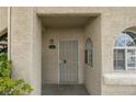 Front door entrance featuring a security gate, charming house number display, and arched window at 2251 Wigwam Pkwy # 716, Henderson, NV 89074