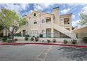 Attractive stucco condo building showcasing well-maintained landscaping, private balconies, and convenient stairwell access at 2251 Wigwam Pkwy # 716, Henderson, NV 89074