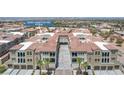 Aerial view of stunning condo building featuring an arched entryway and lush palm trees at 2555 Hampton Rd # 7304, Henderson, NV 89052