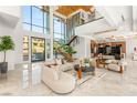 Elegant living room with soaring ceilings, modern furnishings, and natural light from large windows at 2695 Ponte Vecchio Ter, Henderson, NV 89052