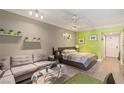 This condo has a modern interior with neutral walls, bright green accent wall and laminate flooring at 30 Strada Di Villaggio # 429, Henderson, NV 89011
