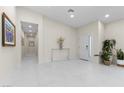 Bright foyer featuring white tile floors, modern lighting, and elegant decor at 3104 Conners Dr, Las Vegas, NV 89107