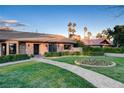 Inviting single-story brick home featuring a stone walkway, manicured lawn, and lush landscaping at 3104 Conners Dr, Las Vegas, NV 89107