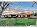 Attractive single-story home featuring a manicured lawn, brick exterior, and delightful garden at 3104 Conners Dr, Las Vegas, NV 89107