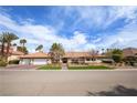 Charming single story home featuring a tile roof, manicured lawn, and double garage doors at 3236 Cliff Sieler Ct, Las Vegas, NV 89117