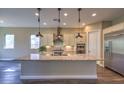 Bright kitchen with granite countertops, stainless steel appliances, and stylish pendant lighting at 3486 Molinos Dr, Las Vegas, NV 89141