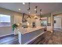 Spacious kitchen features granite counters, stainless appliances, and a center island with pendant lights at 3486 Molinos Dr, Las Vegas, NV 89141