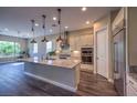 Lovely kitchen with granite countertops, stainless appliances, and an island with bar seating at 3486 Molinos Dr, Las Vegas, NV 89141