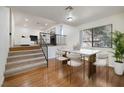 Dining area with wood floors, a modern light fixture, and a marble table at 3972 Tirana Way, Las Vegas, NV 89103