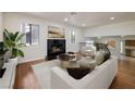 Bright living room featuring wood floors, a fireplace, and modern decor at 3972 Tirana Way, Las Vegas, NV 89103