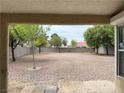 Spacious backyard featuring low-maintenance desert landscaping and block wall for privacy at 4013 Extenso Dr, North Las Vegas, NV 89032