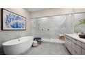 Elegant bathroom featuring a standalone tub, walk-in shower, and modern vanity at 489 Carter House Way, Las Vegas, NV 89138