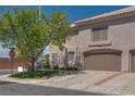 A view of the home's exterior featuring a two-car garage and desert landscaping at 500 Quail Bird Pl, Henderson, NV 89052