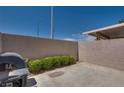 Private patio area with a grill and privacy wall, perfect for outdoor entertaining at 500 Quail Bird Pl, Henderson, NV 89052