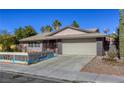 Charming single-story home showcasing a two-car garage, xeriscaping, and desert landscaping at 5132 Springland St, Las Vegas, NV 89146