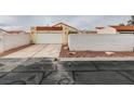 Single-story house showcasing a two-car garage and xeriscape landscaping at 5151 Tennis Ct, Las Vegas, NV 89120